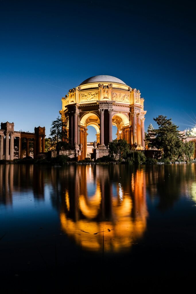 Stunning night view of the illuminated Palace of Fine Arts reflecting in a tranquil lake in San Francisco.